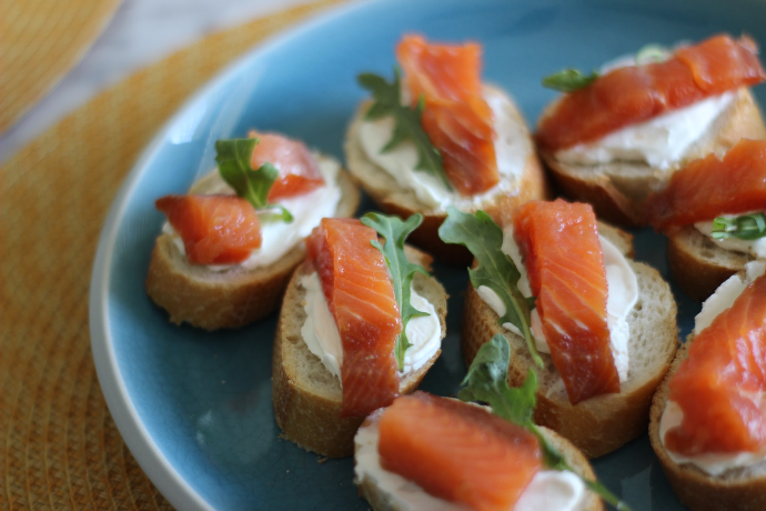 sliced tomato and green leaf vegetable on blue ceramic plate